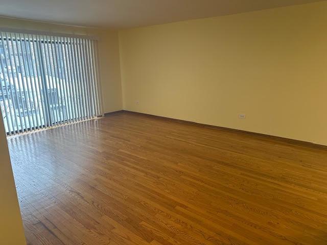 8901 N Western Ave Unit 116, Des Plaines, IL 60016 - unfurnished room featuring baseboards and wood finished floors