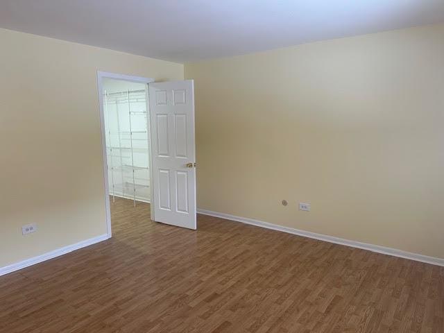 8901 N Western Ave Unit 116, Des Plaines, IL 60016 - empty room with baseboards and dark wood-style floors