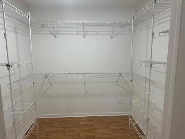 8901 N Western Ave Unit 116, Des Plaines, IL 60016 - walk in closet featuring wood finished floors