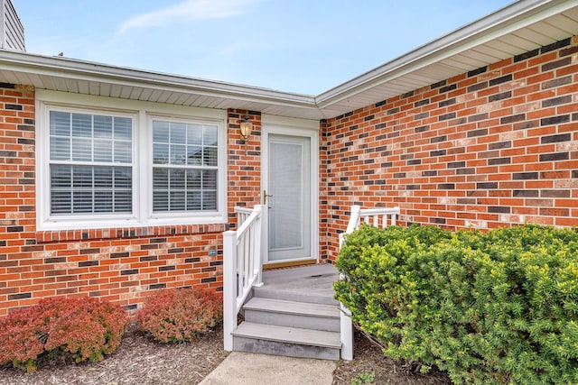 entrance to property with brick siding and crawl space