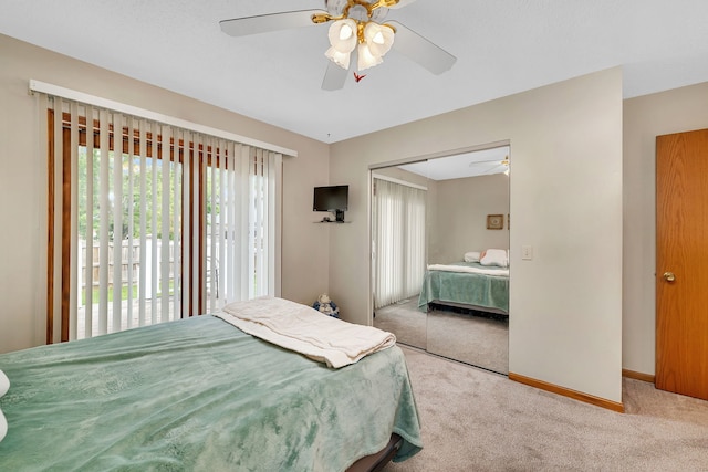 carpeted bedroom featuring a closet, a ceiling fan, and baseboards