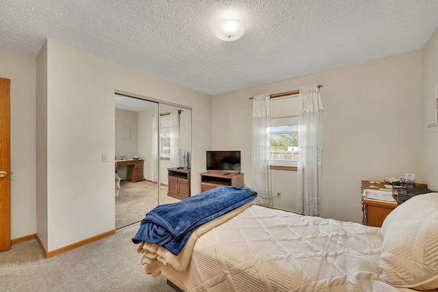 bedroom featuring baseboards, a closet, a textured ceiling, and light colored carpet