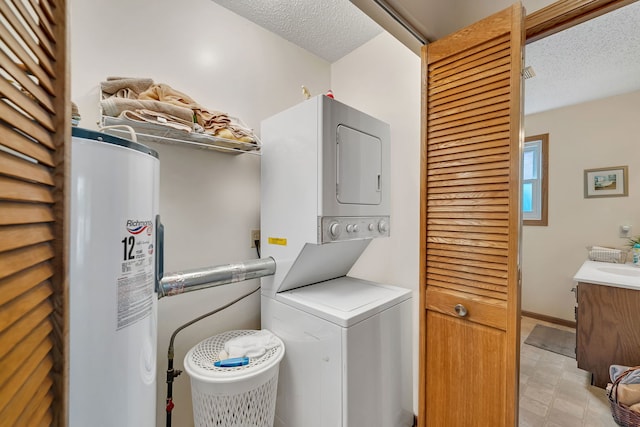 clothes washing area with laundry area, stacked washer and clothes dryer, a textured ceiling, a sink, and water heater
