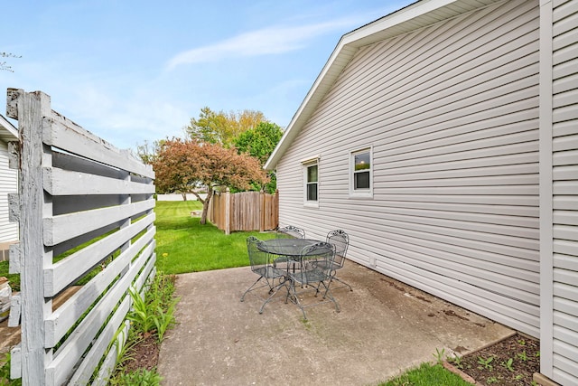 view of patio featuring fence and outdoor dining space