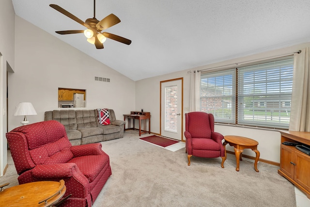 living area featuring ceiling fan, light carpet, high vaulted ceiling, baseboards, and visible vents