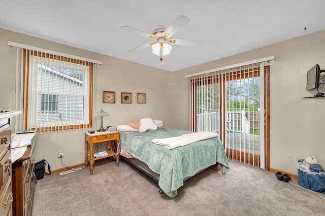 bedroom featuring access to outside, baseboards, and light colored carpet