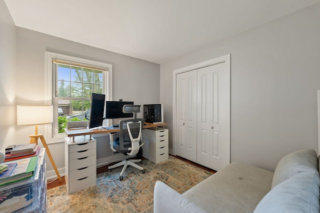 home office featuring baseboards and wood finished floors