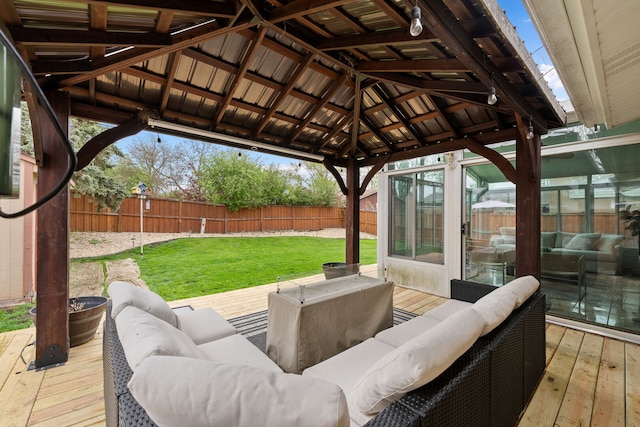 wooden terrace featuring a lawn, a gazebo, outdoor lounge area, and a fenced backyard