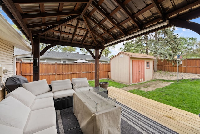 view of patio / terrace featuring a storage shed, an outdoor structure, an outdoor living space, and a fenced backyard