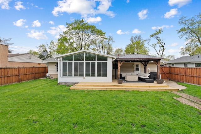 rear view of property with an outdoor hangout area, a wooden deck, a sunroom, a fenced backyard, and a yard