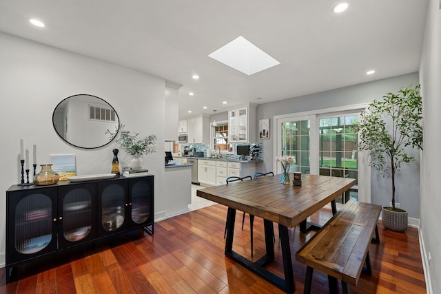 dining area with recessed lighting, a skylight, visible vents, and hardwood / wood-style floors