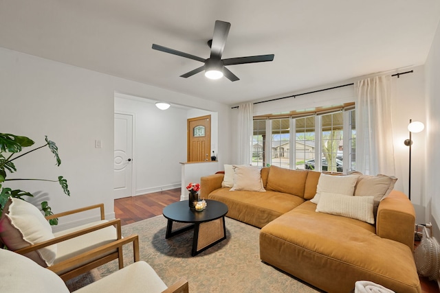 living area with a ceiling fan and wood finished floors