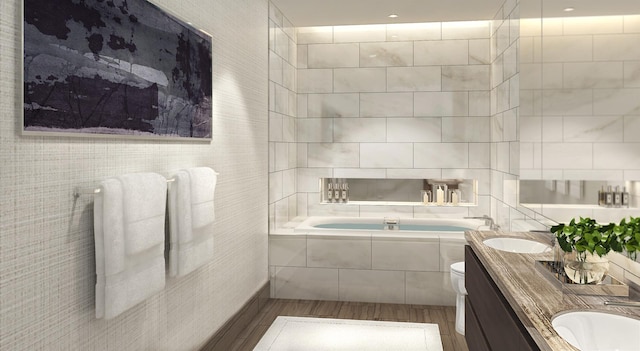 bathroom featuring double vanity, a bath, tile walls, wood finished floors, and toilet