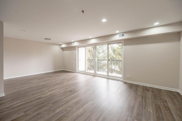 unfurnished room with recessed lighting, baseboards, and wood finished floors