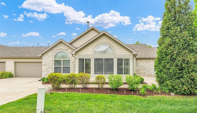2715 J T Coffman Dr Unit 2715, Champaign, IL 61822 - single story home with stone siding, an attached garage, a front lawn, driveway, and roof with shingles