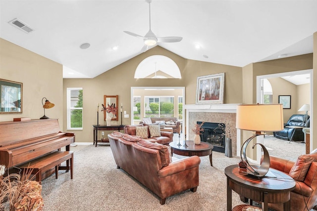 2715 J T Coffman Dr Unit 2715, Champaign, IL 61822 - living area with a ceiling fan, a tiled fireplace, light carpet, baseboards, and high vaulted ceiling