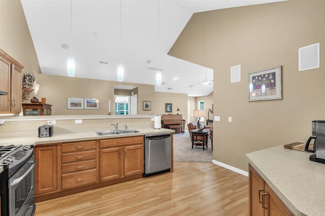 2715 J T Coffman Dr Unit 2715, Champaign, IL 61822 - kitchen featuring stainless steel appliances, a sink, a peninsula, light wood finished floors, and high vaulted ceiling