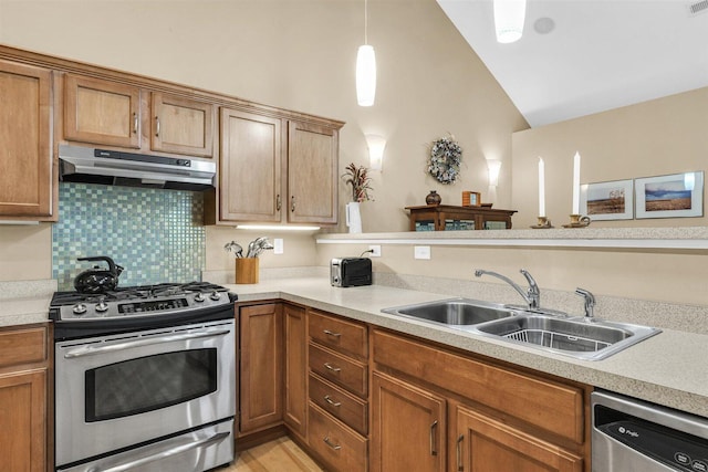 2715 J T Coffman Dr Unit 2715, Champaign, IL 61822 - kitchen with under cabinet range hood, stainless steel appliances, a sink, vaulted ceiling, and light countertops
