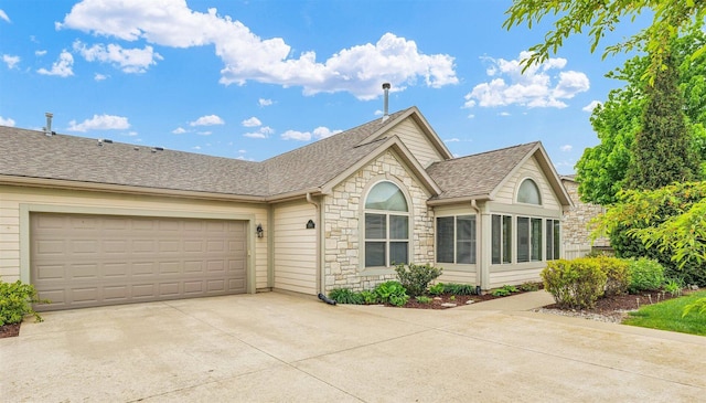 2715 J T Coffman Dr Unit 2715, Champaign, IL 61822 - ranch-style home featuring stone siding, roof with shingles, driveway, and a garage
