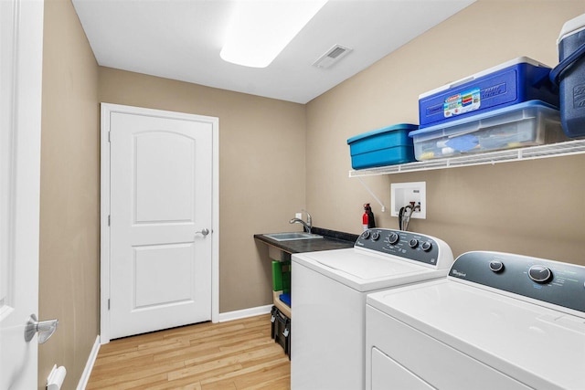 2715 J T Coffman Dr Unit 2715, Champaign, IL 61822 - washroom featuring light wood-style flooring, washer and clothes dryer, and baseboards