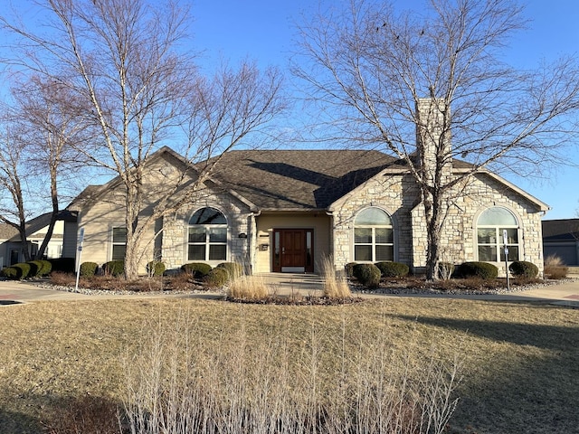 2715 J T Coffman Dr Unit 2715, Champaign, IL 61822 - french country home with stone siding and a front lawn