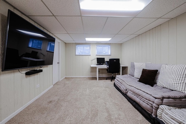 carpeted living room featuring baseboards and a paneled ceiling