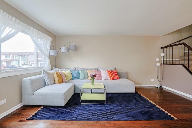 living area with baseboards and wood finished floors