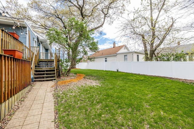 view of yard featuring a deck and stairs