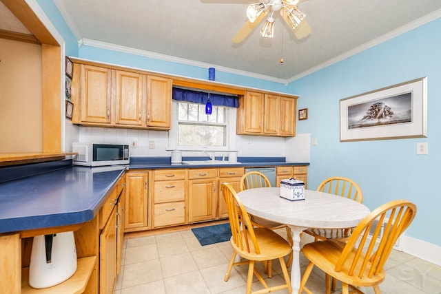 kitchen featuring white microwave, dark countertops, crown molding, tasteful backsplash, and ceiling fan