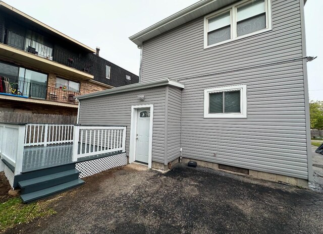 back of property with a wooden deck
