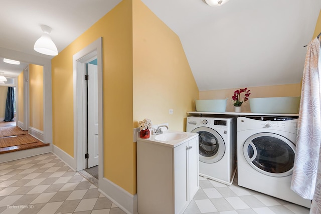 clothes washing area featuring laundry area, separate washer and dryer, and a sink