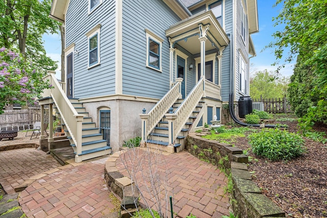 exterior space with central AC unit, a patio area, and fence