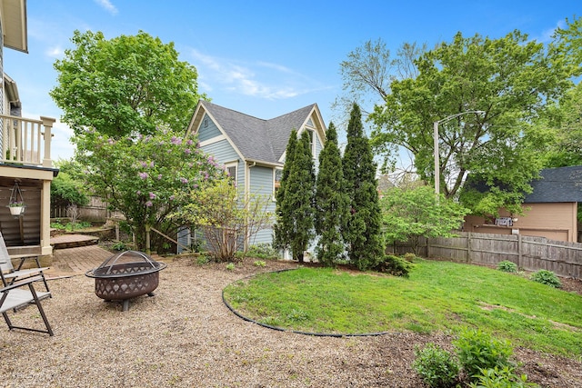 view of yard featuring a fenced backyard and an outdoor fire pit