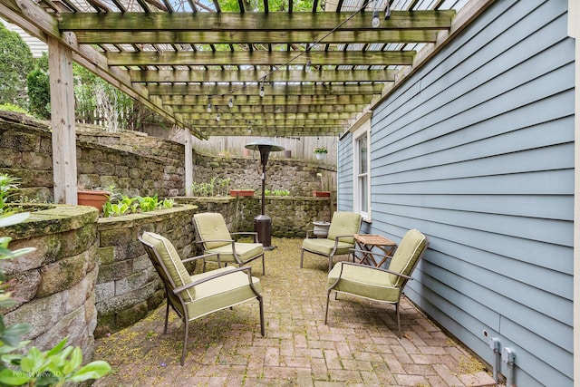 view of patio with a pergola and fence