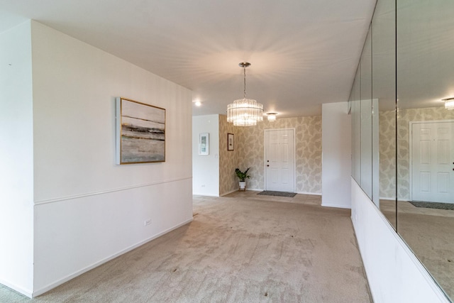 interior space featuring baseboards, an inviting chandelier, and wallpapered walls