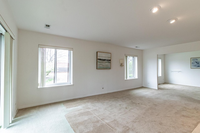 carpeted spare room featuring baseboards