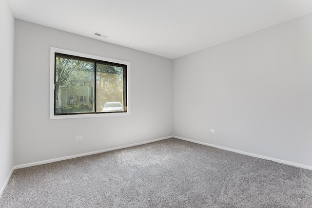 unfurnished room featuring carpet floors and baseboards