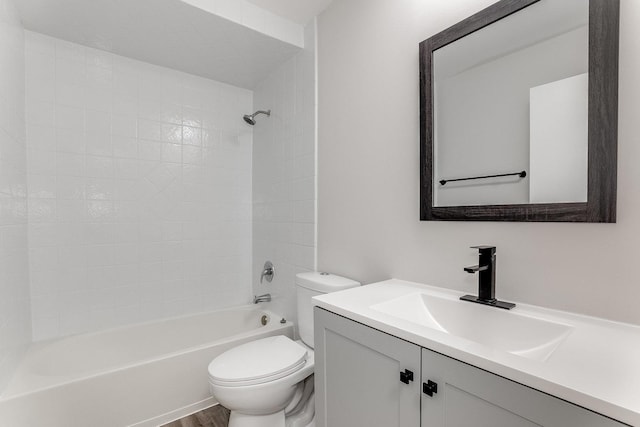bathroom with toilet, vanity, shower / tub combination, and wood finished floors