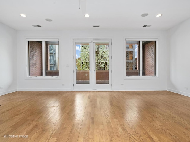spare room with light wood-type flooring, baseboards, and recessed lighting