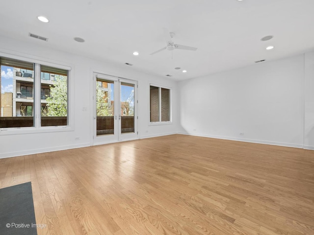 empty room featuring light wood-style flooring, a ceiling fan, recessed lighting, and baseboards
