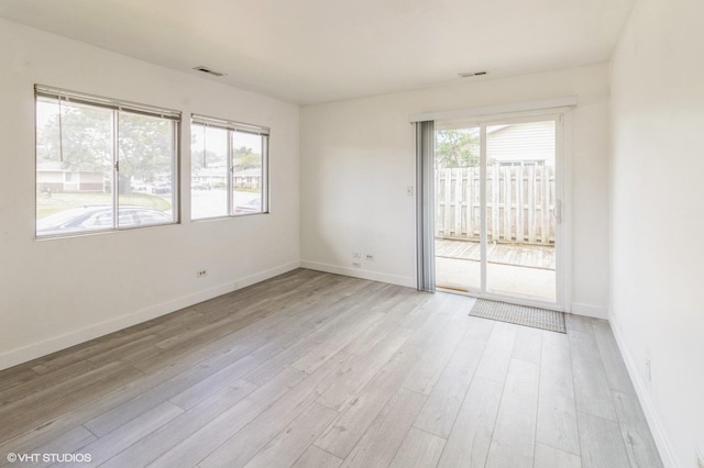 empty room with light wood-style flooring and baseboards