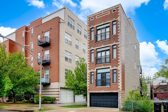 937 N Willard Ct Unit 1, Chicago, IL 60642 - view of building exterior featuring an attached garage and concrete driveway
