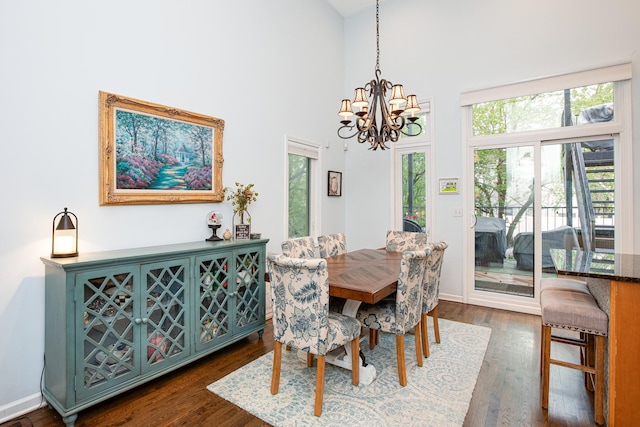 937 N Willard Ct Unit 1, Chicago, IL 60642 - dining room with a chandelier, dark wood-type flooring, a towering ceiling, and baseboards