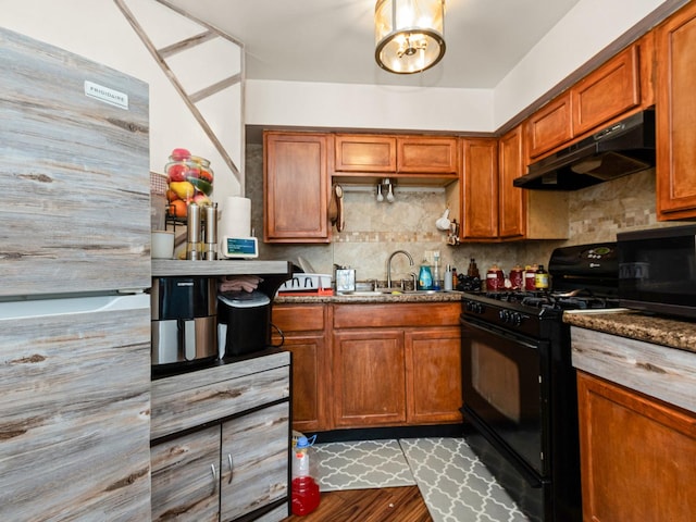2720 E 76th Pl, Chicago, IL 60649 - kitchen with black appliances, under cabinet range hood, tasteful backsplash, and a sink