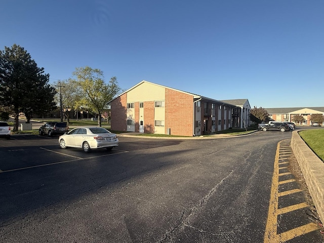 view of asphalt street with curbs