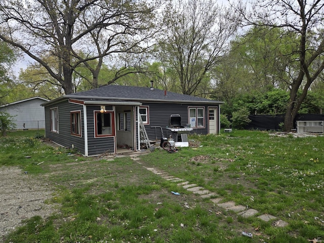 rear view of property with a yard