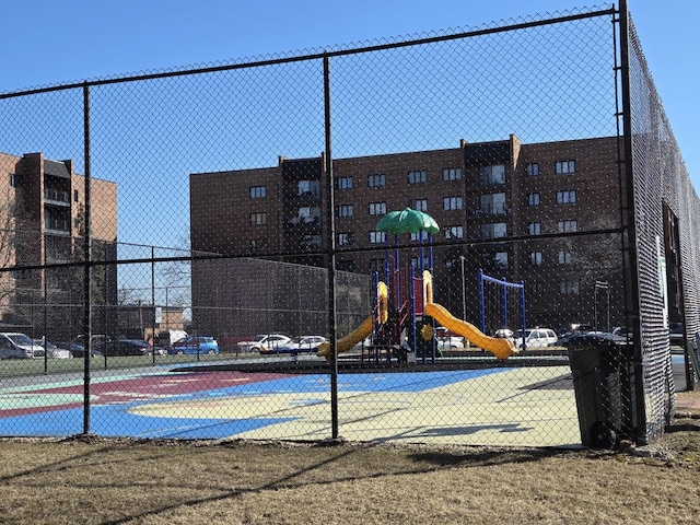 view of sport court with fence and playground community