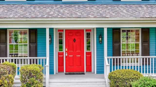 entrance to property with roof with shingles