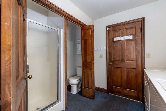 bathroom featuring toilet and a shower stall