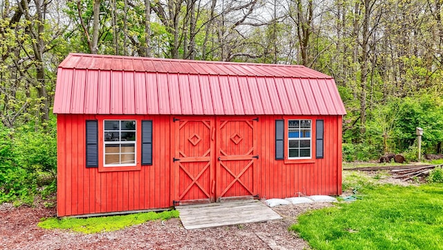 view of shed with a wooded view